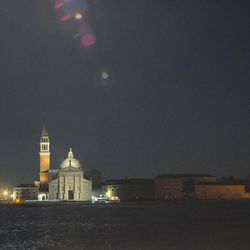 Illuminated temple against sky at night