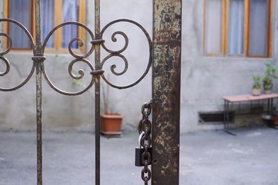 Close-up of metal gate against building