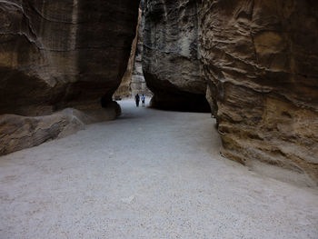 Rear view of man standing in cave