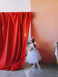 Full length of woman dancing with umbrella