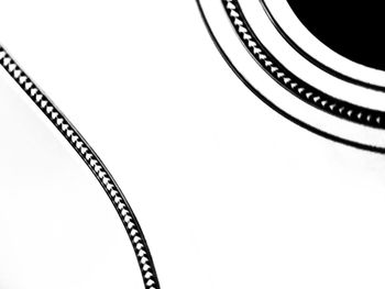 Close-up of metal object over white background