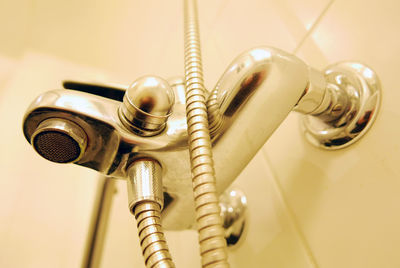 Low angle view of hand shower in bathroom