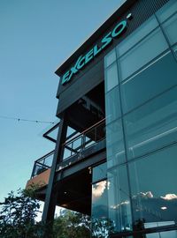 Low angle view of modern building against clear blue sky