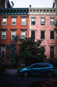 Cars on street by buildings in city