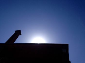 Low angle view of built structure against clear blue sky