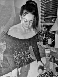 Portrait of woman looking at table at home