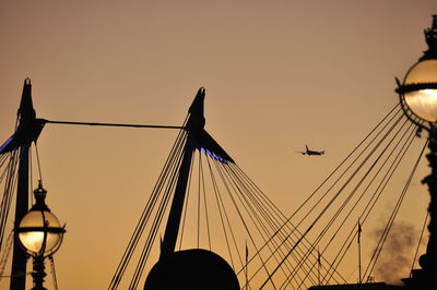 Low angle view of silhouette airplane against clear sky