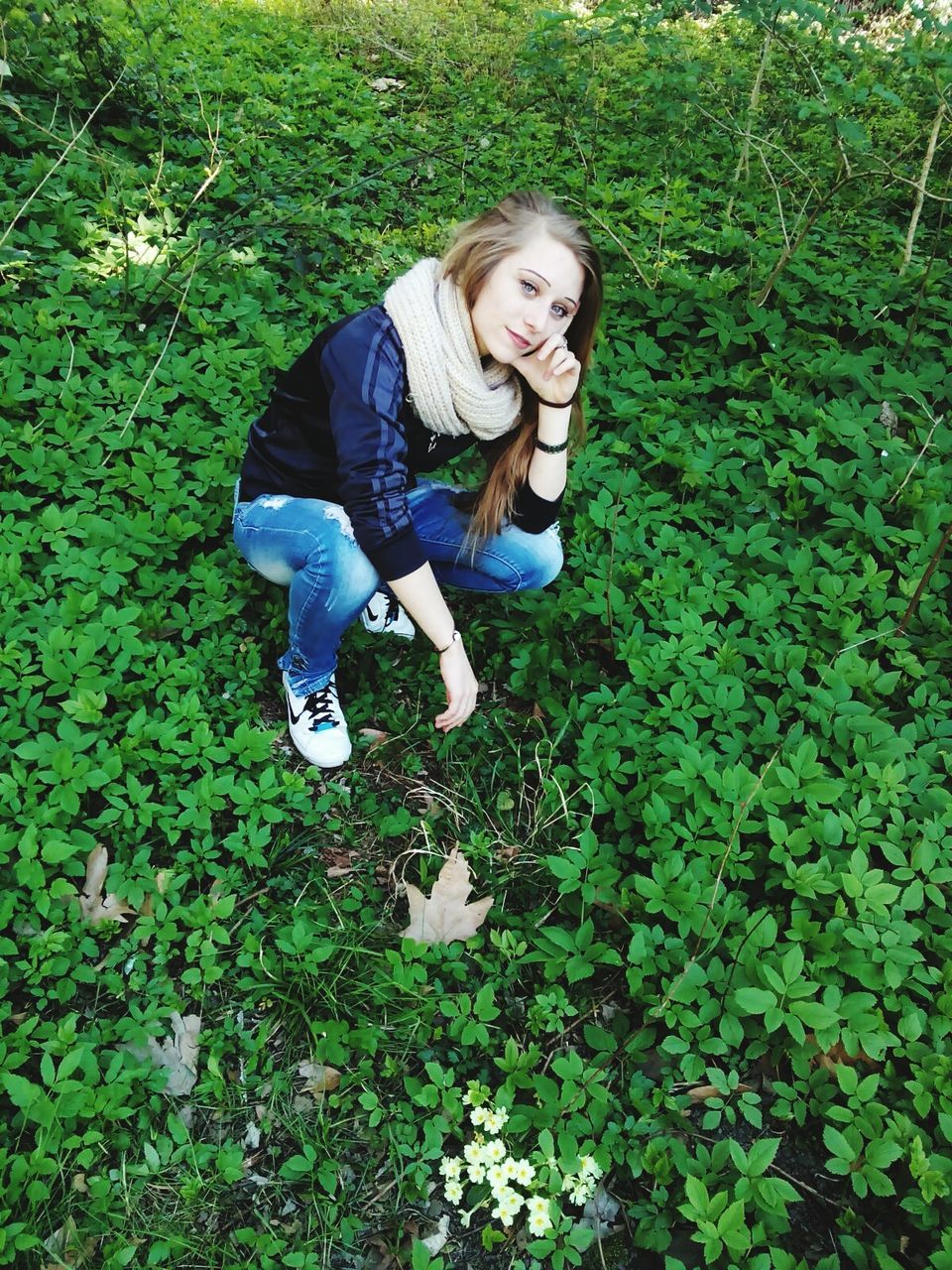 person, grass, casual clothing, lifestyles, portrait, leisure activity, looking at camera, high angle view, young adult, field, smiling, growth, full length, green color, plant, front view, standing, happiness