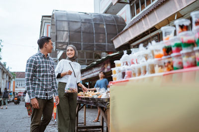 Rear view of woman standing in city