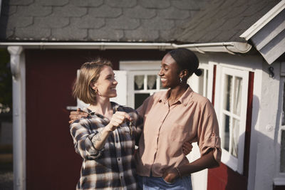 Smiling women holding house keys