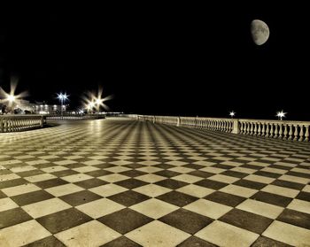 Illuminated lights against sky at night