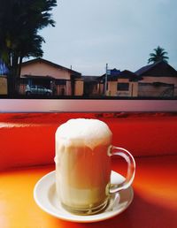 Close-up of coffee served on table against sky