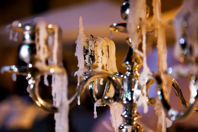 Close-up of illuminated lighting equipment hanging at night