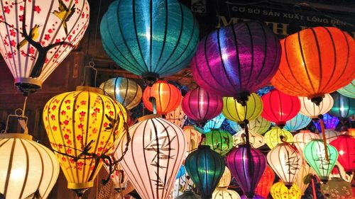Low angle view of lanterns hanging in market at night