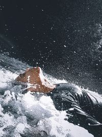 Person splashing water in winter