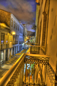 Illuminated buildings against sky at night