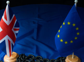 Close-up of flags with chain on table