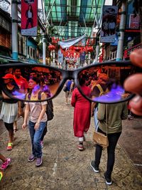 Group of people walking on street in city