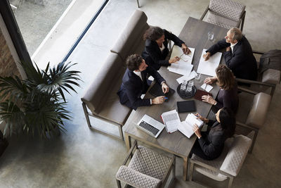 Team of lawyers planning with business colleagues during meeting at law firm