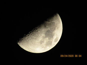 Low angle view of half moon against sky at night