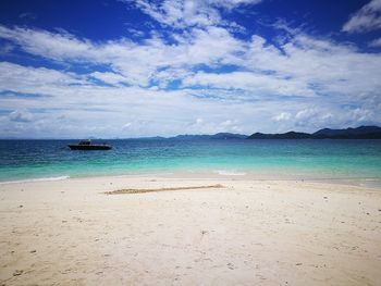 View of beach against cloudy sky