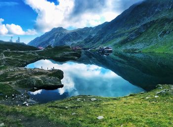 Scenic view of lake and mountains against sky