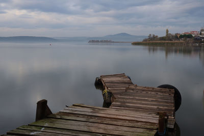 Pier over lake against sky