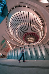 Rear view of woman walking in corridor