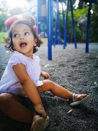 Cute girl sitting in playground