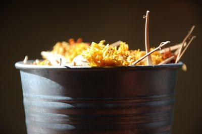 Close-up of food in bowl on table against black background