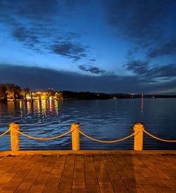 Pier over sea against sky at dusk