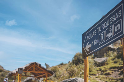 Low angle view of road sign against sky