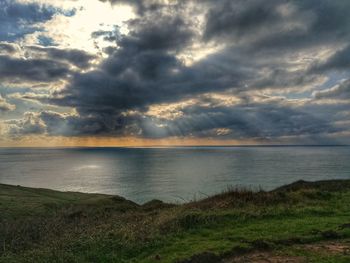 Scenic view of sea against cloudy sky