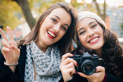 Portrait of happy woman photographing