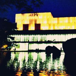 Reflection of illuminated built structure in water