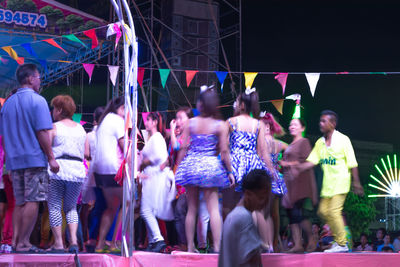 Group of people dancing at music concert