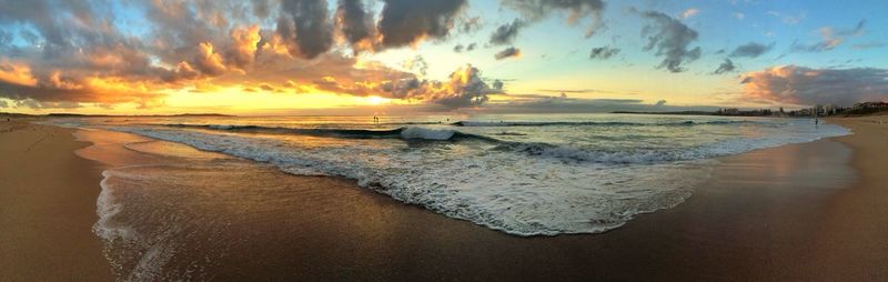 Panoramic view of beach against sky during sunset