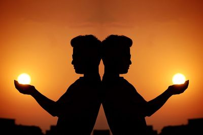 Multiple image silhouette of man holding sun against sky during sunset