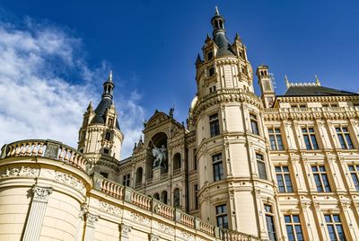 Low angle view of historical building against blue sky