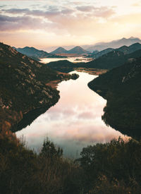 Scenic view of lake against sky during sunset