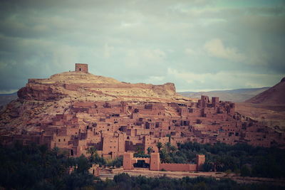 Ancient structure against cloudy sky