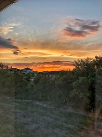 Scenic view of field against sky during sunset