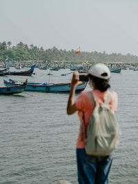 Rear view of man standing in sea