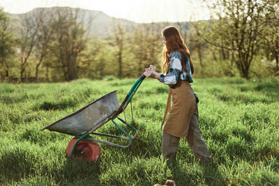 Rear view of woman standing on field