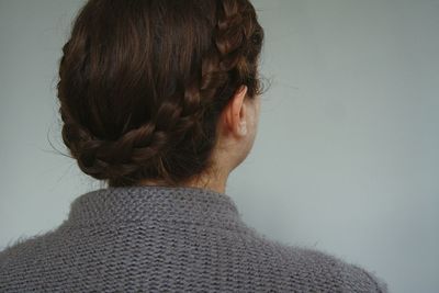 Rear view of woman against gray background