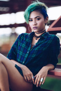 Portrait of young woman sitting outdoors