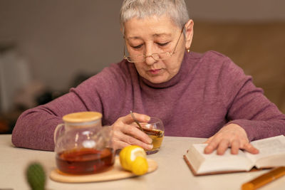 Portrait of senior man sitting on table