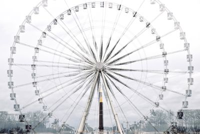 Ferris wheel spinning against sky