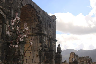 Low angle view of old ruin against sky