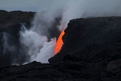 Scenic view of volcanic mountain against sky